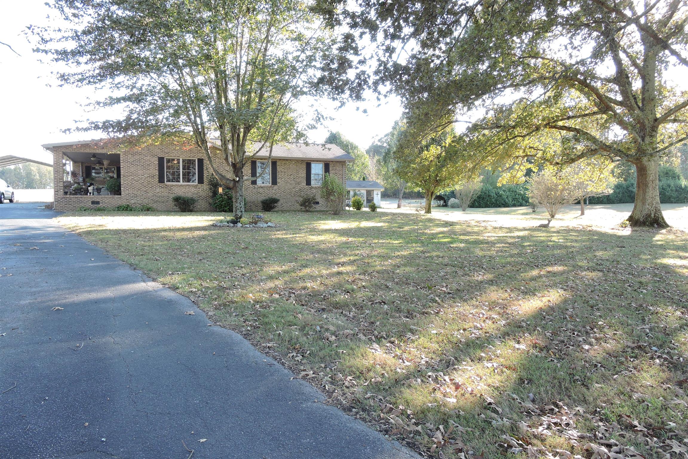 826 Wayside Road Manchester, TN 37355 - Photo 3 of 31 a front view of a house with a garden and trees