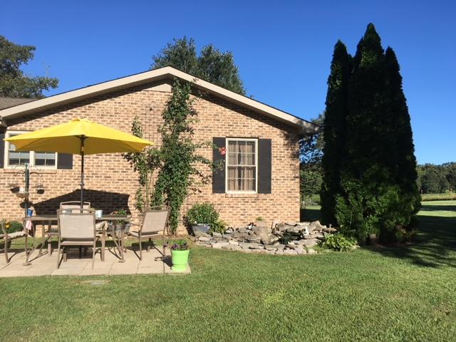 826 Wayside Road Manchester, TN 37355 - Photo 31 of 31 a view of backyard with a garden and outdoor seating