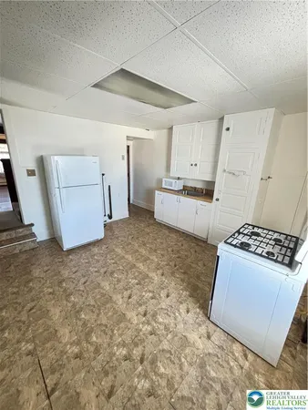 a kitchen with a stove and white cabinets