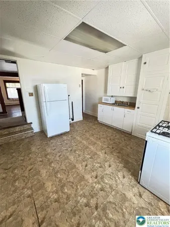 a room with a stove top oven and sink