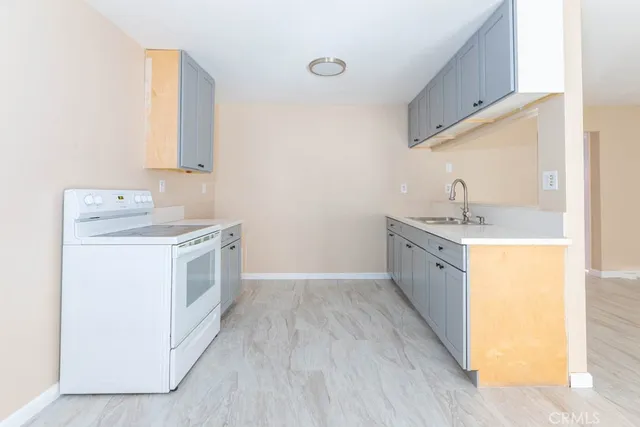 a utility room with cabinets washer and dryer