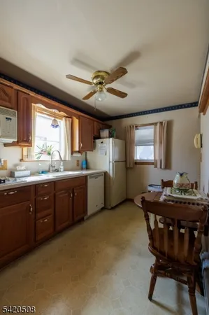 a kitchen with a stove a sink a dining table and chairs