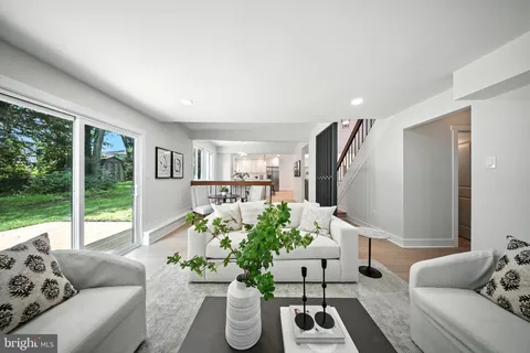 a living room with furniture fireplace and a large window