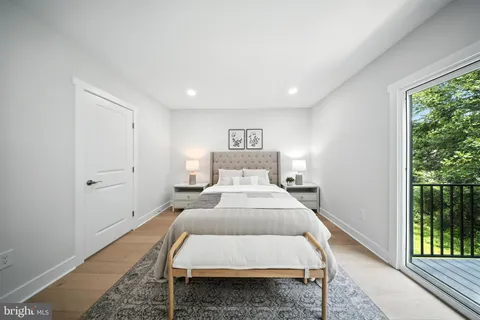 a bed room with a bed and a painting on the wall