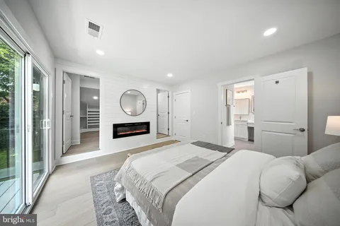 a bedroom with a large bed and a large window