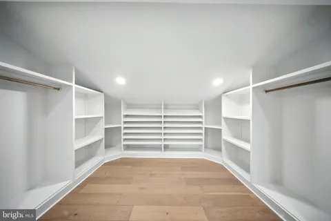 a view of walk in closet with empty racks