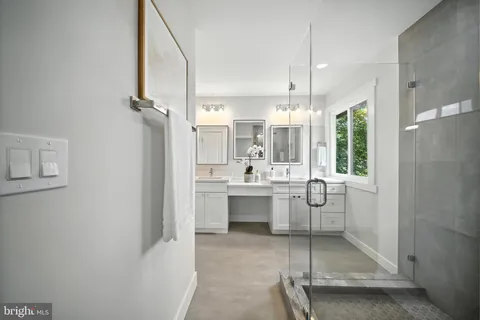 a bathroom with a sink mirror and a shower