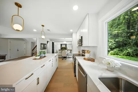 a kitchen that has a lot of cabinets a sink and a stove