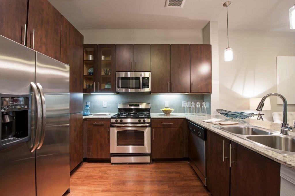 2525 McCue Road, Unit 553 Houston, TX 77056 - Photo 2 of 16 a kitchen with stainless steel appliances granite countertop a sink stove and refrigerator