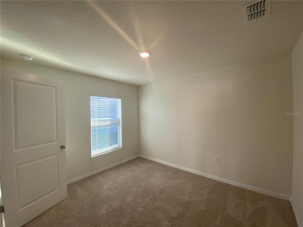 308 Hickory Course Radiel Ocala, FL 34472 - Photo 17 of 24 an empty room with windows