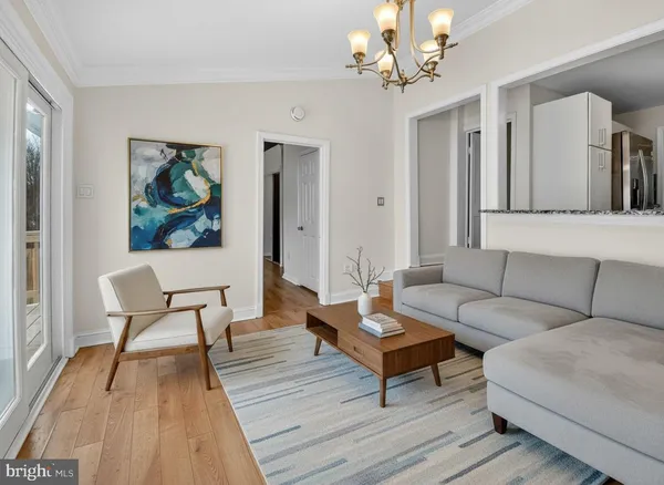a living room with furniture and a chandelier