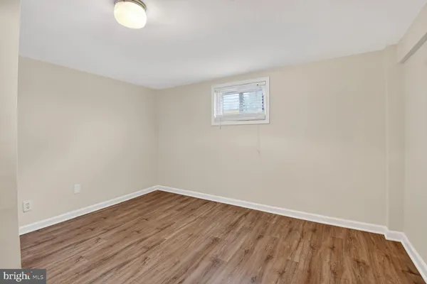 a view of a room with wooden floor and white walls