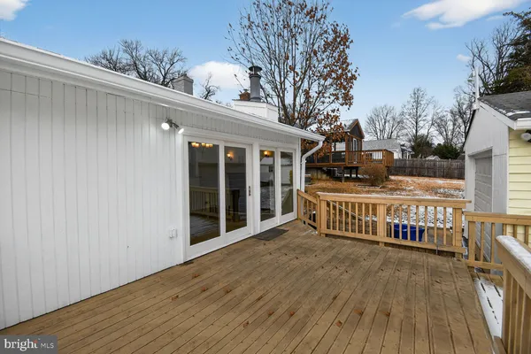 a view of a porch with wooden floor and fence