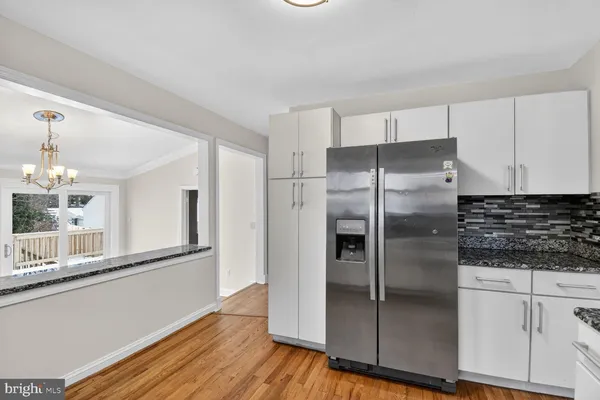 a kitchen with stainless steel appliances granite countertop a refrigerator and a stove