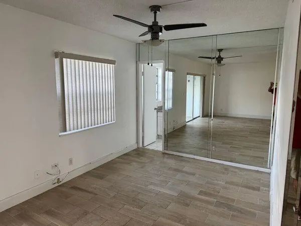 an empty room with windows and entrance