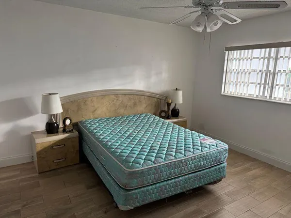 a bed sitting in a bedroom next to a window