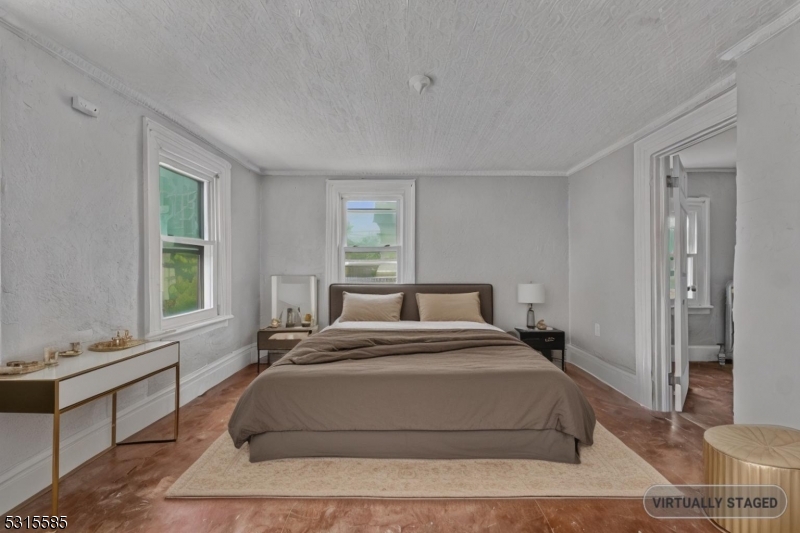 403 Seminary Avenue Rahway, NJ 07065 - Photo 14 of 29 a spacious bedroom with a large bed and a window