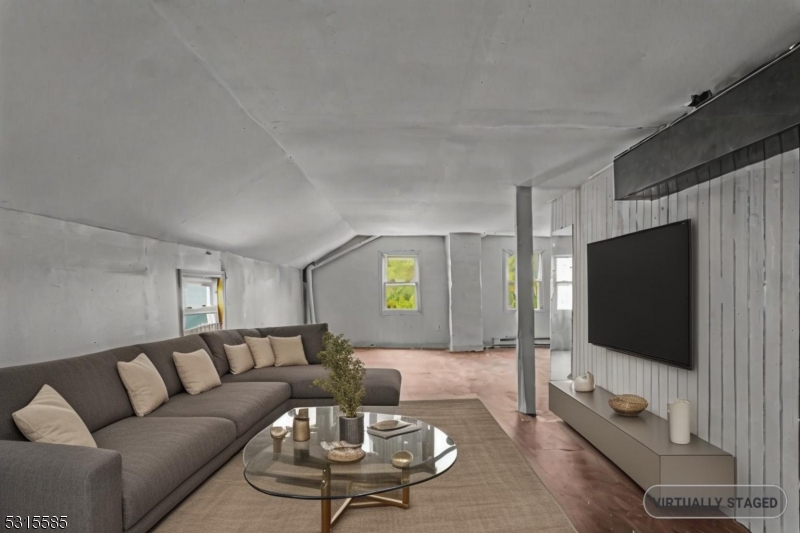 403 Seminary Avenue Rahway, NJ 07065 - Photo 24 of 29 a living room with furniture and a flat screen tv