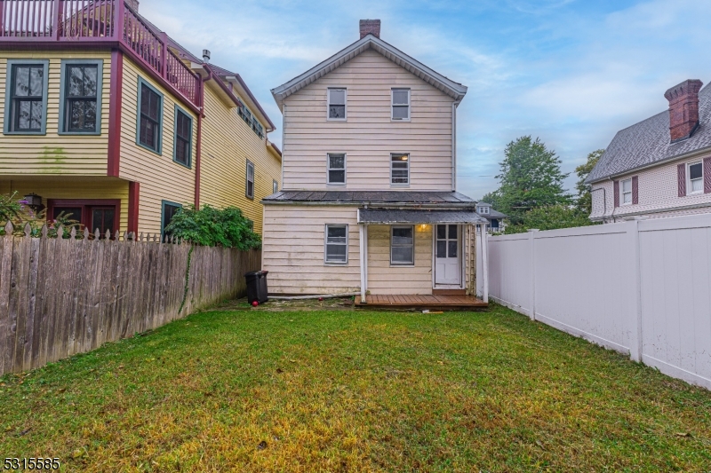 403 Seminary Avenue Rahway, NJ 07065 - Photo 27 of 29 a view of a house with a yard and wooden fence