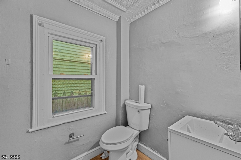 403 Seminary Avenue Rahway, NJ 07065 - Photo 7 of 29 a white toilet sitting next to a bathroom sink