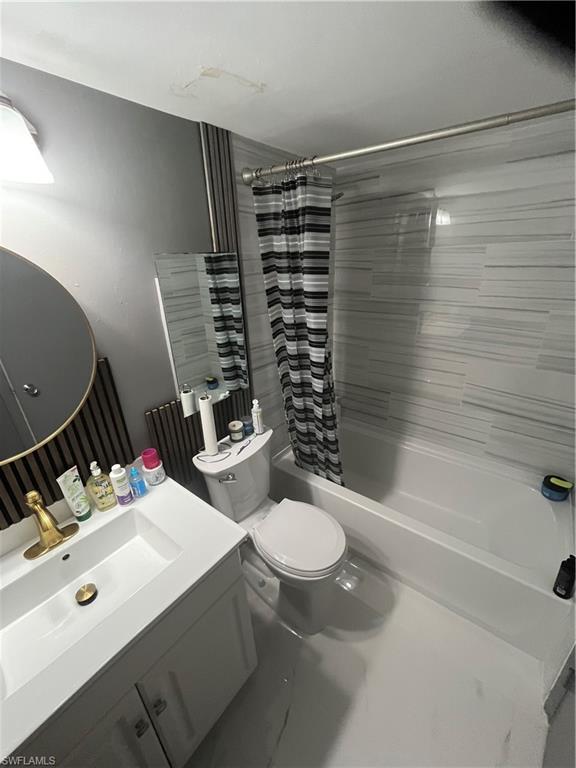3 Bluebill Avenue, Unit 207 Naples, FL 34108 - Photo 12 of 27 Bathroom with vanity and shower / bath combination with curtain
