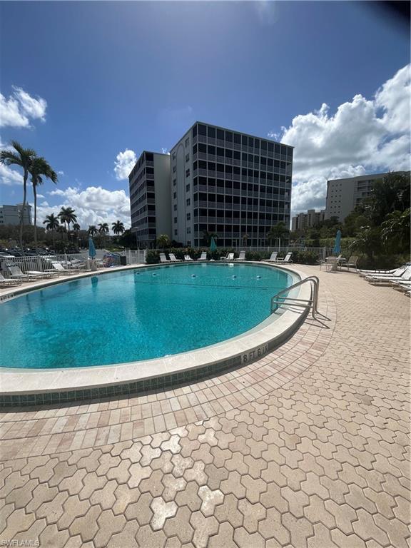 3 Bluebill Avenue, Unit 207 Naples, FL 34108 - Photo 5 of 27 Community pool featuring a patio area