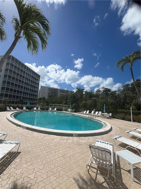 3 Bluebill Avenue, Unit 207 Naples, FL 34108 - Photo 6 of 27 Community pool with a patio