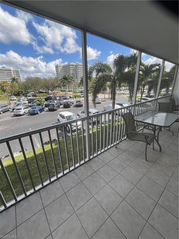 3 Bluebill Avenue, Unit 207 Naples, FL 34108 - Photo 8 of 27 Balcony with a sunroom