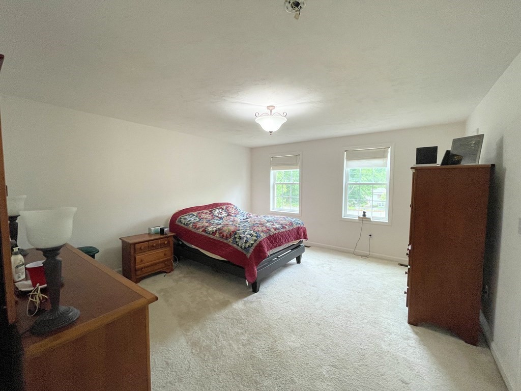 149 Groton Road Shirley, MA 01464 - Photo 15 of 32 a bedroom with a bed and wooden floor