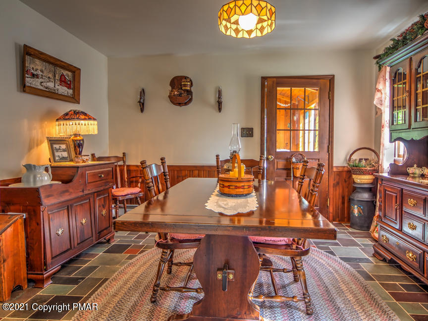 259 Babbling Brook Road Scotrun, PA 18355 - Photo 11 of 63 a view of a dining room with furniture a chandelier and wooden floor