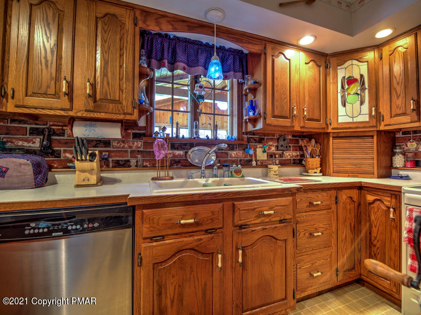 259 Babbling Brook Road Scotrun, PA 18355 - Photo 14 of 63 a kitchen with stainless steel appliances granite countertop a sink and cabinets