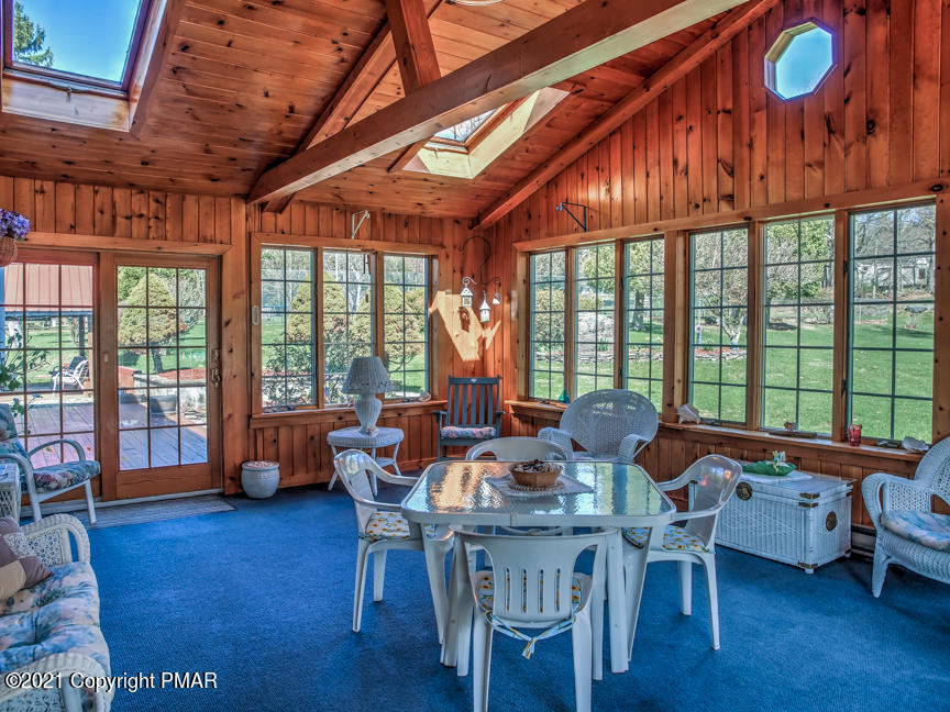 259 Babbling Brook Road Scotrun, PA 18355 - Photo 20 of 63 a dining room with furniture a chandelier and wooden floor