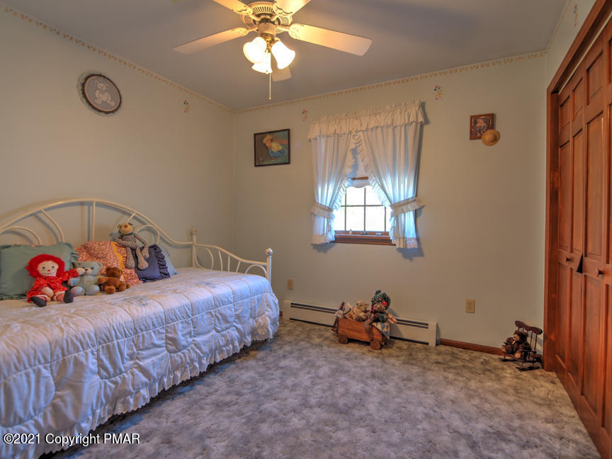 259 Babbling Brook Road Scotrun, PA 18355 - Photo 42 of 63 a bedroom with bed and a chandelier