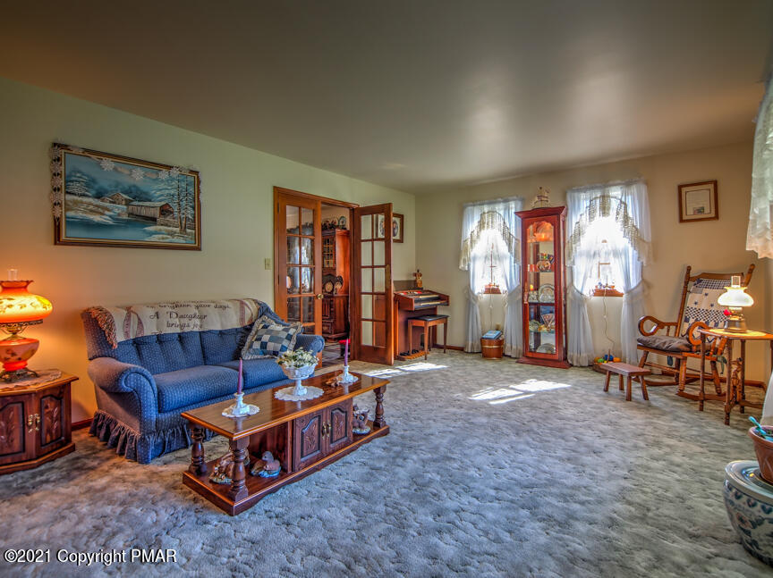 259 Babbling Brook Road Scotrun, PA 18355 - Photo 6 of 63 a living room with furniture and a lamp