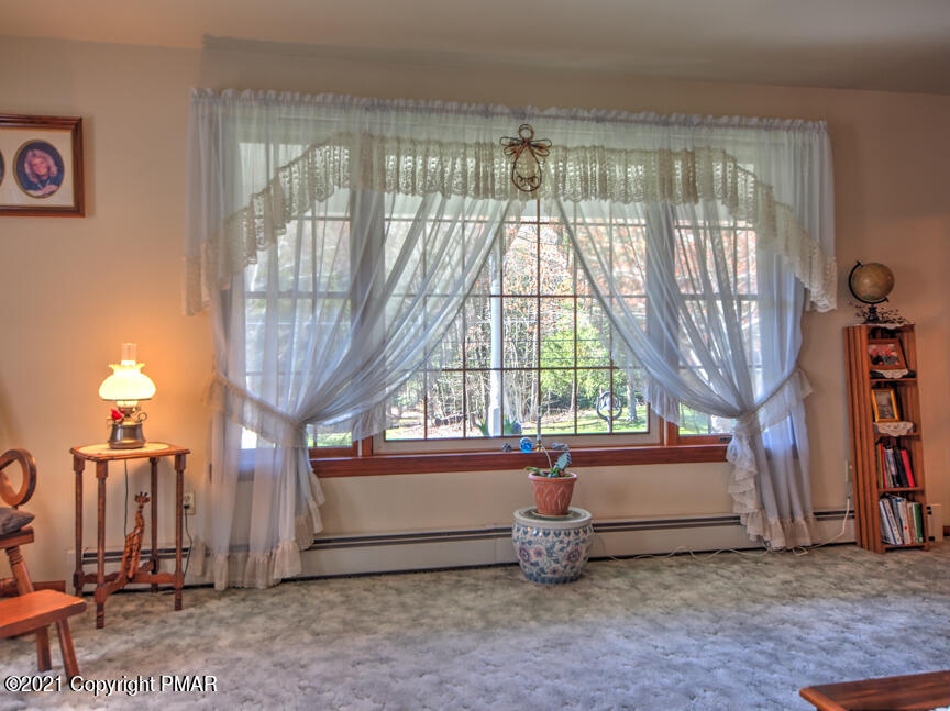 259 Babbling Brook Road Scotrun, PA 18355 - Photo 8 of 63 a view of an empty room with a fireplace and a large window