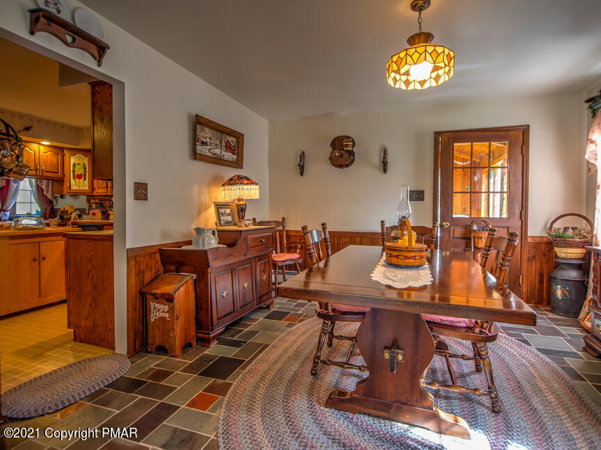 259 Babbling Brook Road Scotrun, PA 18355 - Photo 10 of 63 a view of a dining room with furniture a chandelier and wooden floor