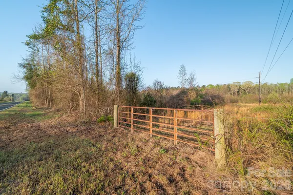 a view of a yard with wooden fence