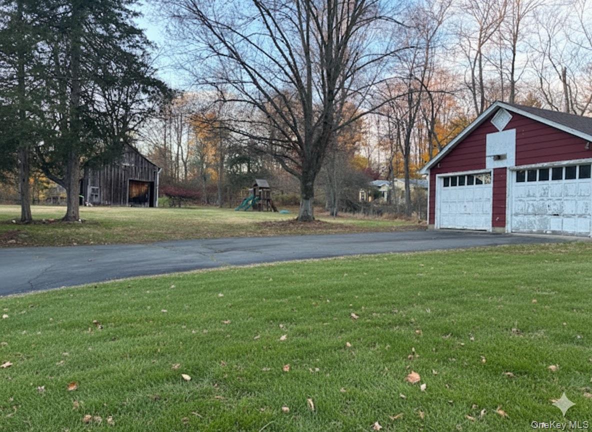 269 Old Rte 304 New City, NY 10956 - Photo 19 of 20 a front view of a house with a yard and garage