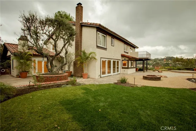 a house view with swimming pool and garden