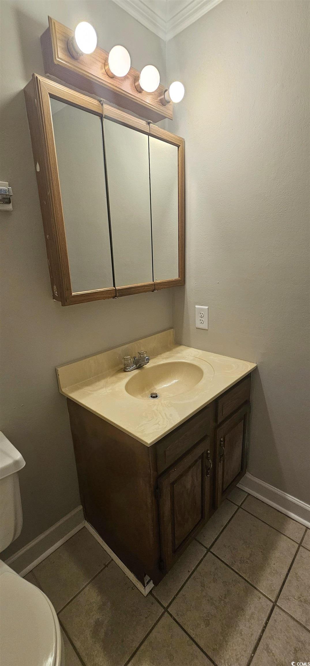 615 Carter Lane, Unit A1 Conway, SC 29526 - Photo 16 of 24 Half bath featuring vanity, light tile patterned floors, and crown molding