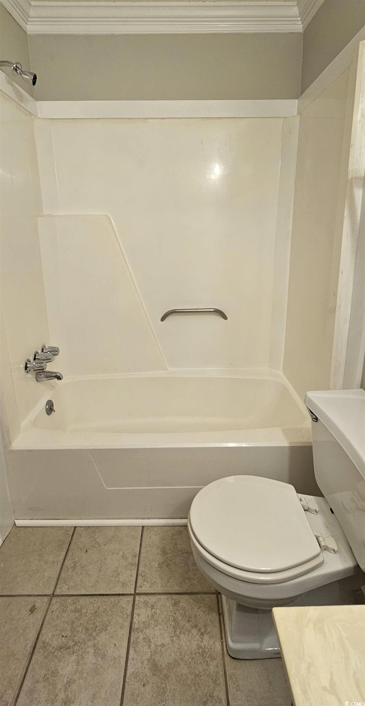 615 Carter Lane, Unit A1 Conway, SC 29526 - Photo 17 of 24 Full bath with ornamental molding, light tile patterned flooring, and shower combination