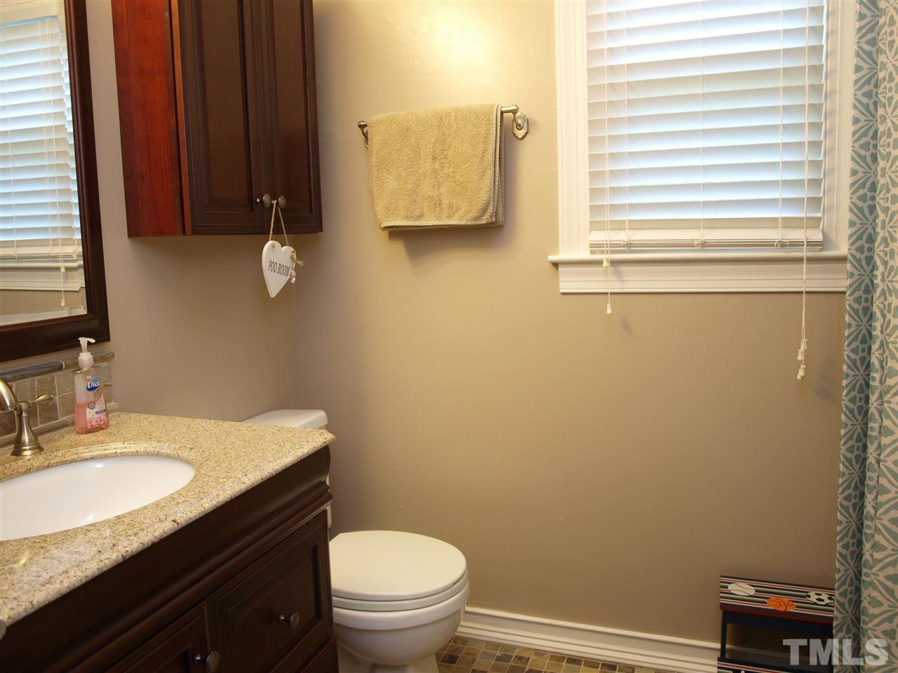 5729 Sentinel Drive Raleigh, NC 27609 - Photo 8 of 17 a bathroom with a granite countertop toilet sink and mirror