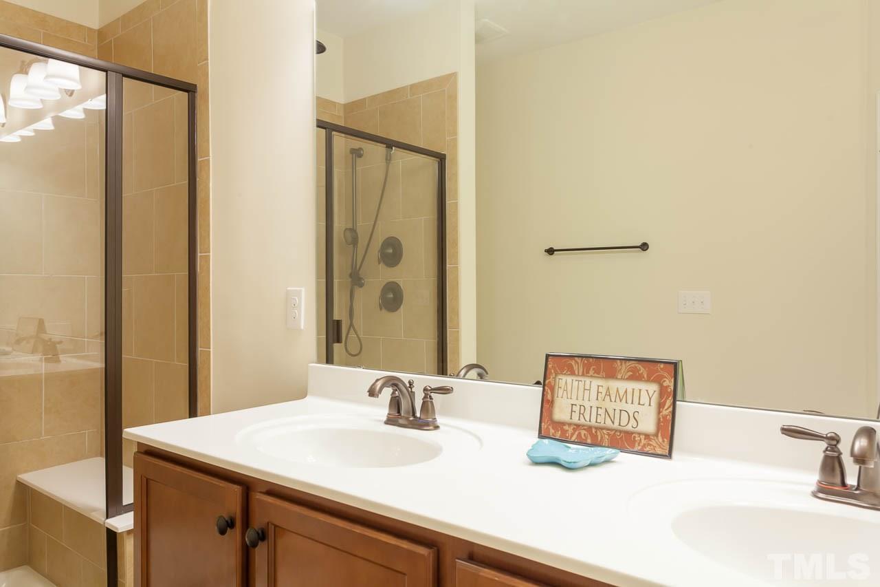 7326 Caversham Way Raleigh, NC 27617 - Photo 16 of 23 a bathroom with a sink and a mirror