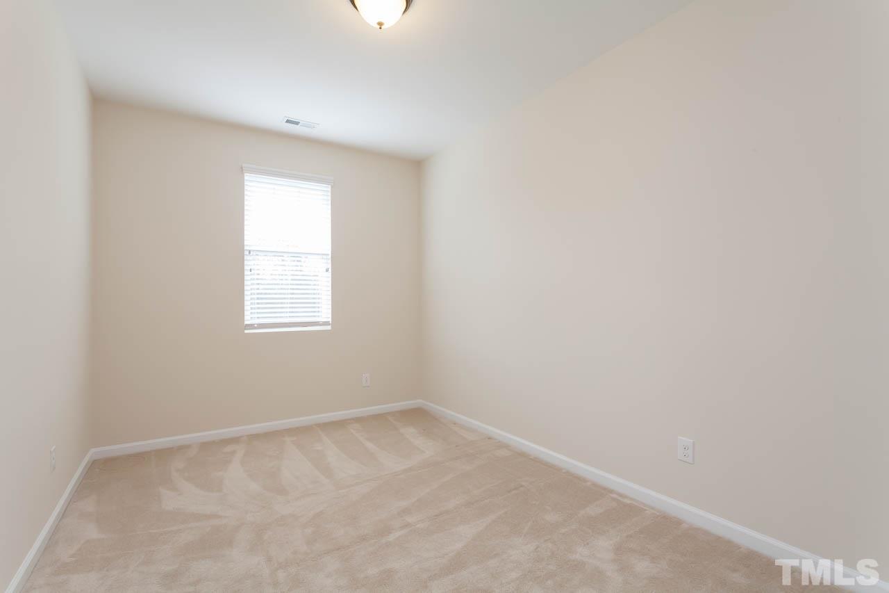 7326 Caversham Way Raleigh, NC 27617 - Photo 18 of 23 an empty room with a window
