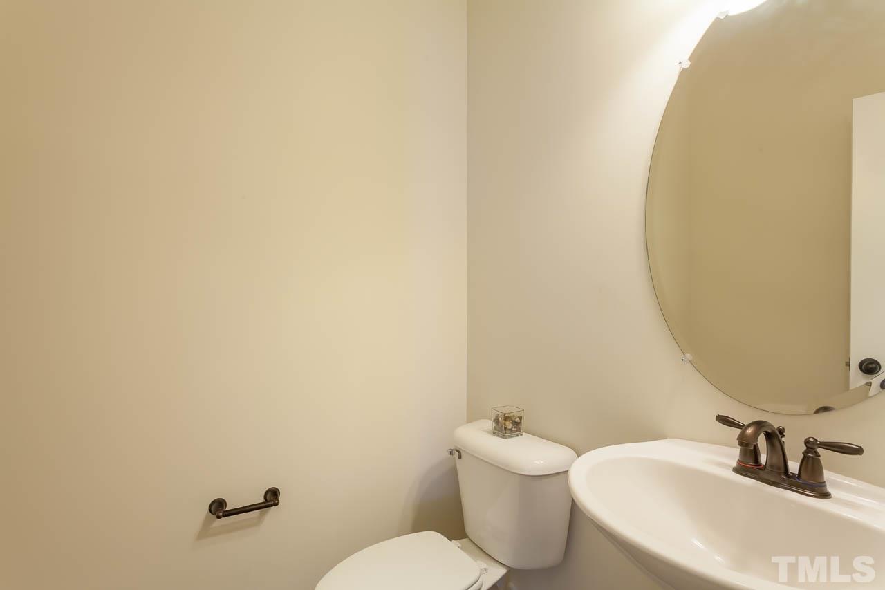 7326 Caversham Way Raleigh, NC 27617 - Photo 19 of 23 a bathroom with a toilet sink and mirror
