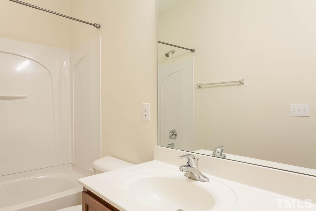7326 Caversham Way Raleigh, NC 27617 - Photo 21 of 23 a bathroom with a sink and a mirror