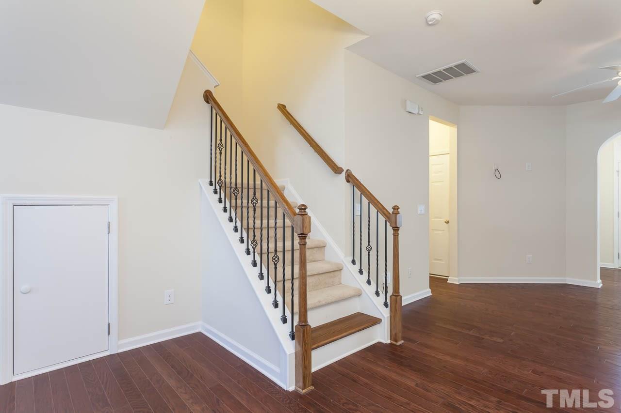 7326 Caversham Way Raleigh, NC 27617 - Photo 7 of 23 a view of a hallway with wooden floor and entryway
