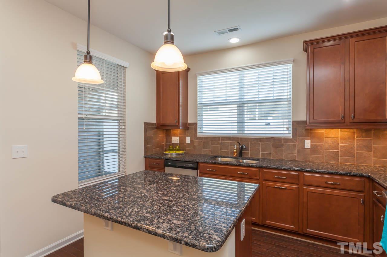 7326 Caversham Way Raleigh, NC 27617 - Photo 10 of 23 a kitchen with granite countertop sink and window