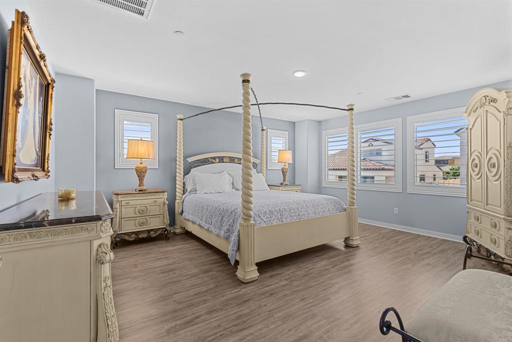 29809 Gypsy Vanner Way Menifee, CA 92584 - Photo 29 of 45 a bedroom with a bed and wooden floor