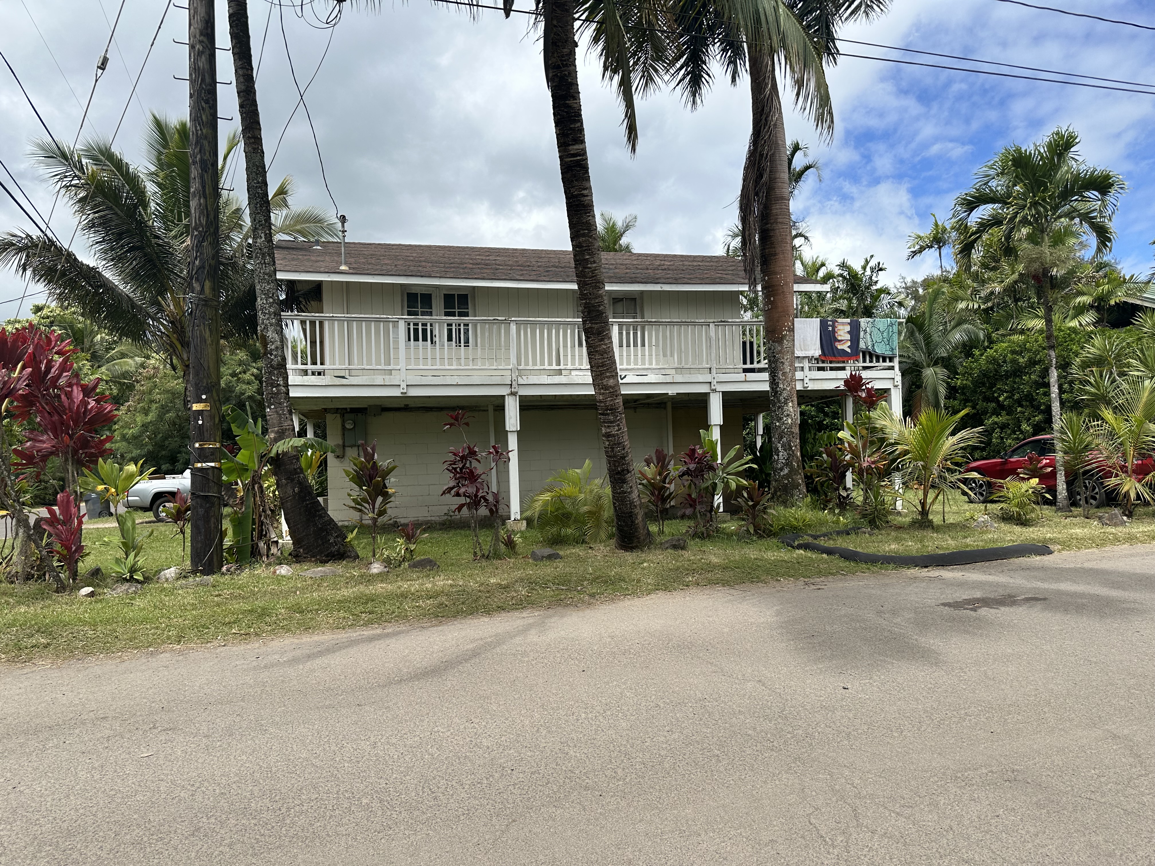 5404 Weke Road Hanalei, HI 96714 - Photo 1 of 19 a front view of a house with a garden and trees